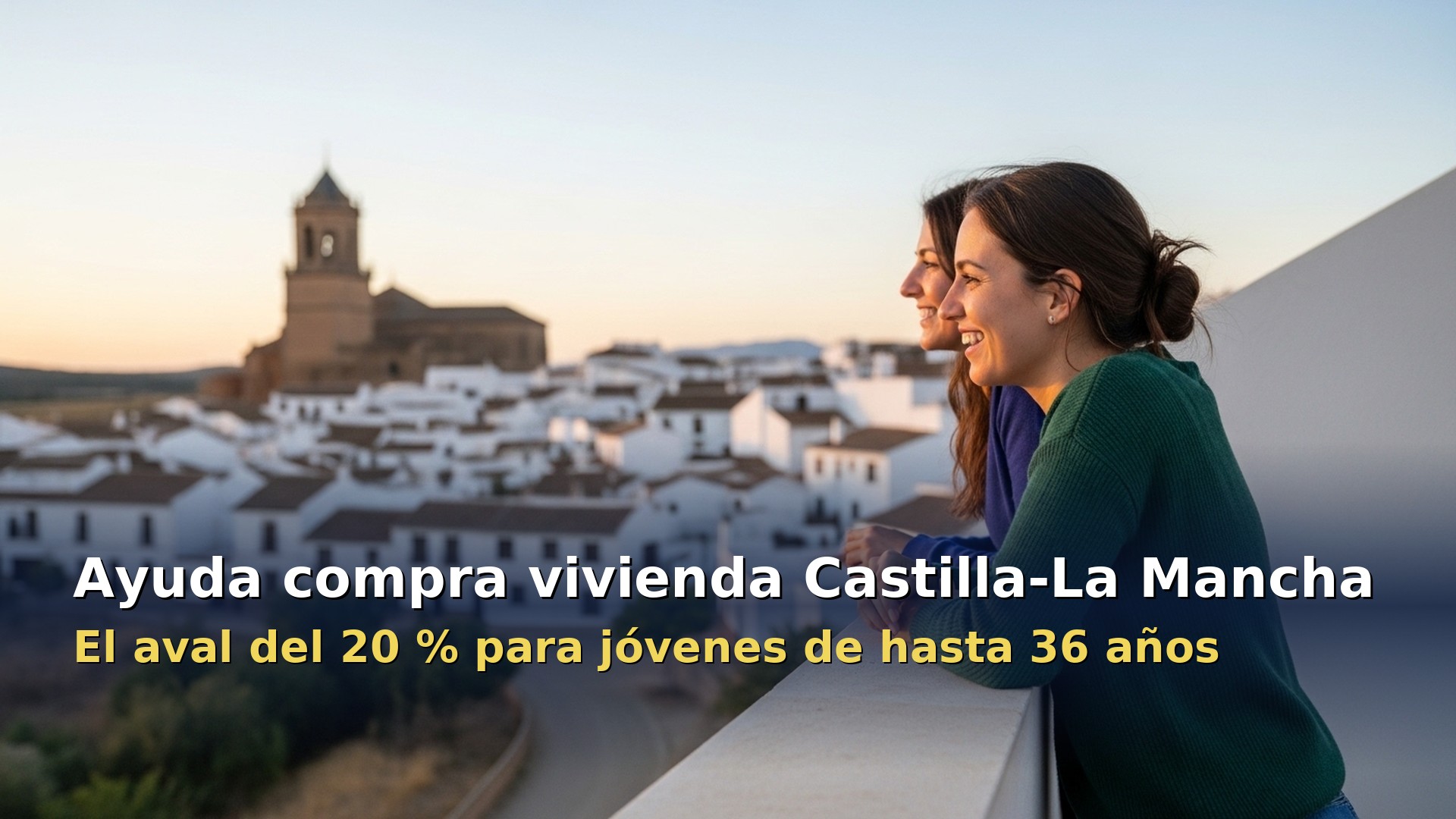 Ayuda compra vivienda Castilla-La Mancha: dos jovenes miran un pueblo manchego desde la terraza de su piso